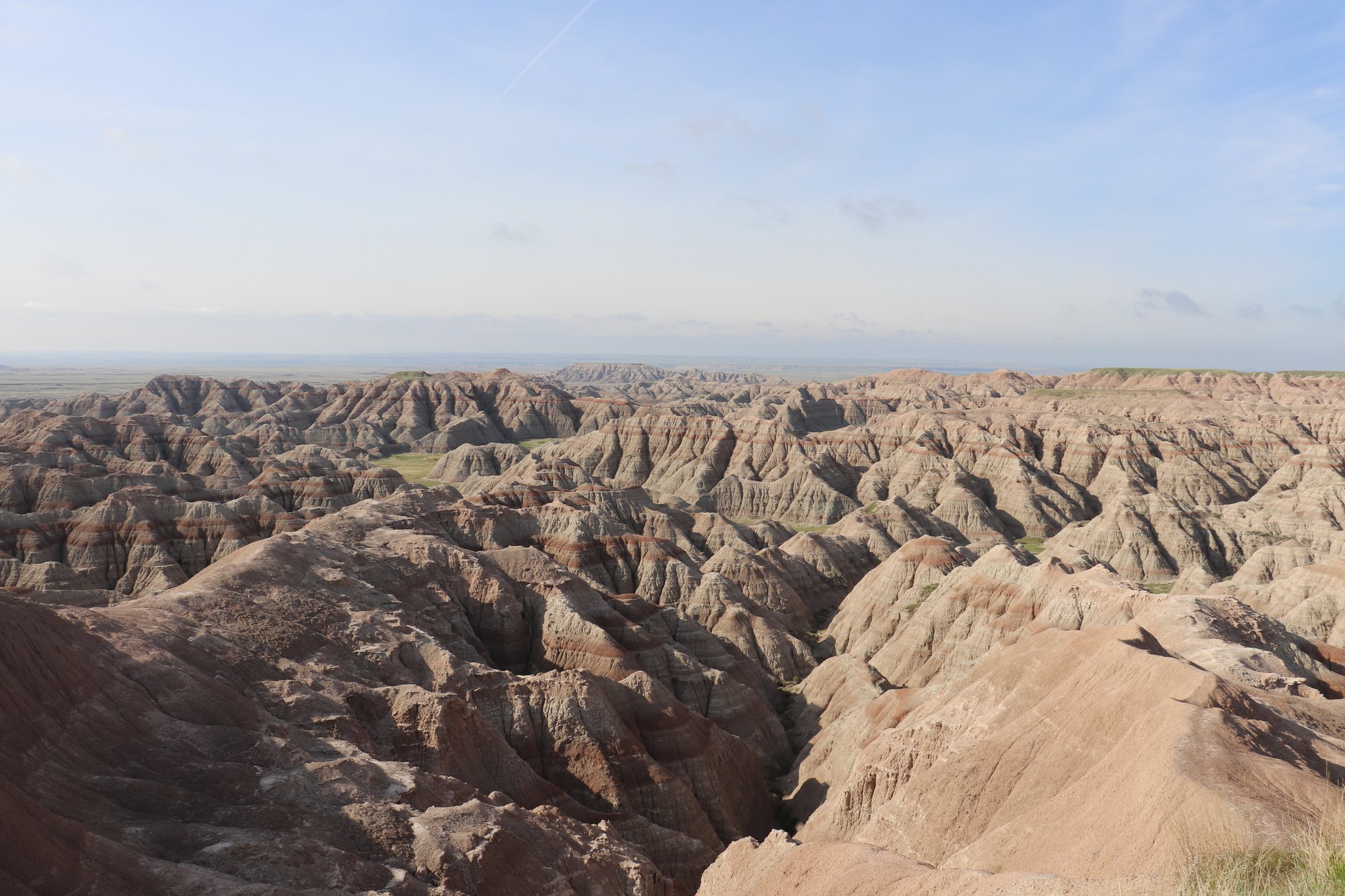 Eroded, banded rock formations stretching to the horizon in the Badlands